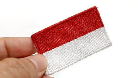 Hand Holding an Indonesian Flag Patch. Happy Anniversary Independence Day of Indonesia, August 17Th...