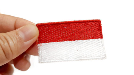 Hand Holding an Indonesian Flag Patch. Happy Anniversary Independence Day of Indonesia, August 17Th...