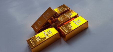 Shiny Gold Bullion Bars on Gray Background. Financial Concept