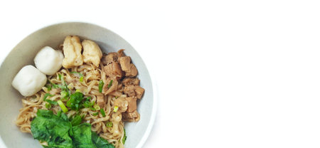 Mie Ayam Indonesian Chicken Noodle Soup with Fish Balls in a Bowl Isolated on White Background. Food Photographyの写真素材