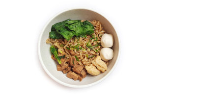 Mie Ayam Indonesian Chicken Noodle Soup with Fish Balls in a Bowl Isolated on White Background. Food Photographyの写真素材