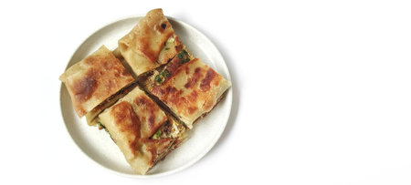 Martabak Telor or Egg Martabak is Fried Pastry Stuffed with Egg, Meat and Spices Served On a Plate....