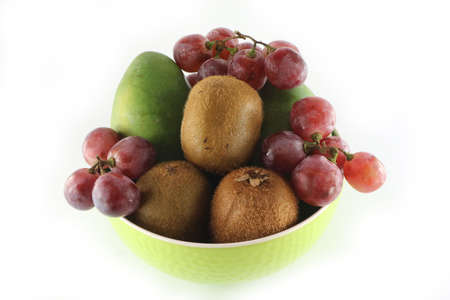 Fruits in a bowl isolated on a white backgroundの写真素材