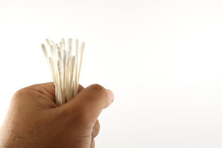 Hand holding cotton budsの写真素材