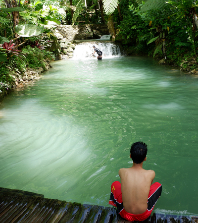 activities of people swimming in the river in the forestの写真素材