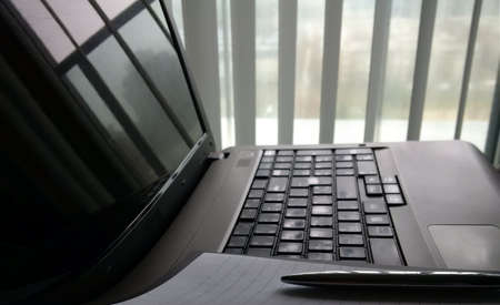 Laptop Keyboard with Paper and Penの写真素材