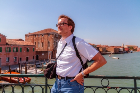 Tourist at Murano  German tourist on the island of Murano near Venice in September standing on a bridgeの写真素材
