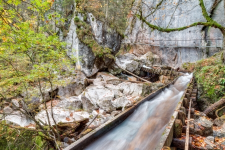 Valley with Watercourse and Waterfalls in Autumn near Neuschwanstein, Germany, taken in autumn Octoberの写真素材