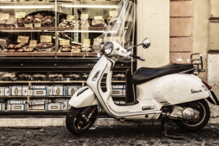 Editorial  ROME, ITALY - MARCH 29 2014  Old Vespa Scooter in front of a backery in the old town of Rome on MARCH 29 2014 in Rome in Italyのeditorial素材