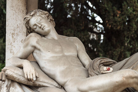 ROME, ITALY - MARCH 25 2014: Outdoor Picture of a Statue of a naked young man from the famous Cemetary Campo Verano near San Lorenzo on March 25 2014 in Rome in Italyのeditorial素材