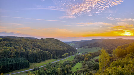 Idyllic Autumn Scenery near a lovely Country Road in the rocky Jura Mountains of Bavaria, Germany. Sunset in Fall with a wonderful sky in the rural countryside.の写真素材