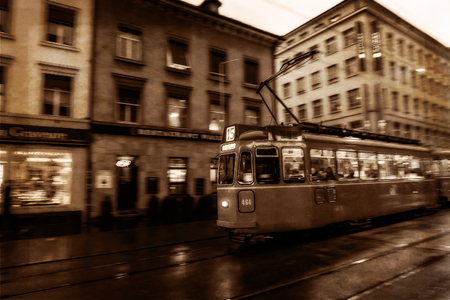 Tram in the swiss city of Basel in the evening on a cold and snowy winter day. Evening in Switzerlandのeditorial素材