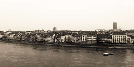 Water Front at the Rhine river in the Swiss City of Basel. Historical Buildings on a snowy and cold winter day in Januaryの写真素材