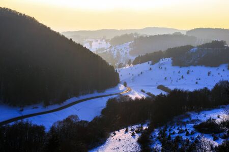 Cold snowy winter sunset in Bavaria, Germany. Sweet Solitude. White and Lonely hill Landscape....