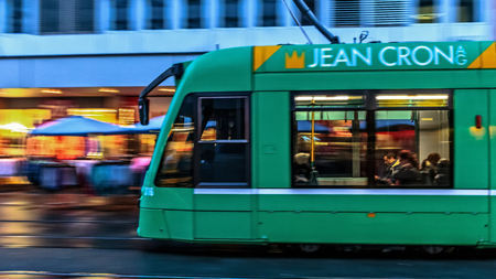 Tram in the swiss city of Basel in the evening on a cold and snowy winter day. Evening in Switzerlandのeditorial素材