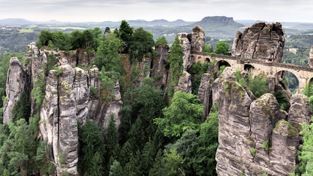Bastion Bridge in the Saxonian Swiss in Germany, shot on a warm summer morning after sunrise. Landmark of Saxonia near Dresden. Sandstone Rock Formations. Bridge leading to a former medieval castleのeditorial素材