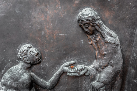 WUERZBURG, GERMANY - MARCH 08 2015: Charity Picture from a Door the Catholic Christian Cathedral of...