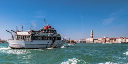 VENICE, ITALY - SEPTEMBER 07 2013: Lagoon of Venice. Boats and Medieval Architecture on a hot september dayのeditorial素材
