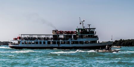 VENICE, ITALY - SEPTEMBER 07 2013: Lagoon of Venice. Boats and Medieval Architecture on a hot september dayのeditorial素材