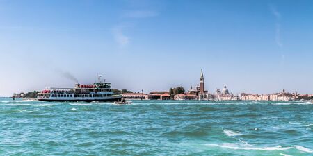 VENICE, ITALY - SEPTEMBER 07 2013: Lagoon of Venice. Boats and Medieval Architecture on a hot september dayのeditorial素材