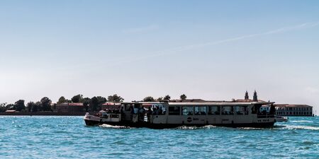 VENICE, ITALY - SEPTEMBER 07 2013: Lagoon of Venice. Boats and Medieval Architecture on a hot september dayのeditorial素材