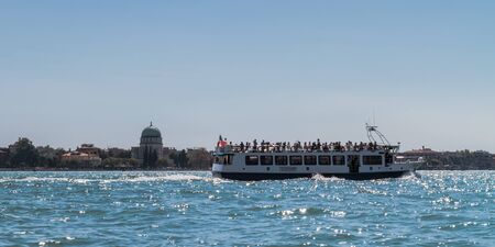 VENICE, ITALY - SEPTEMBER 07 2013: Lagoon of Venice. Boats and Medieval Architecture on a hot september dayのeditorial素材