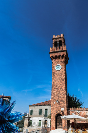 MURANO, ITALY - SEPTEMBER 06 2013: Scene from the Canals of Murano. Boats on the water. Old Architecture. Sunny Blue Skyのeditorial素材