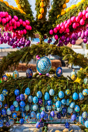 LAUF, GERMANY - APRIL 09 2015: Easter Tradition: Masterfully Colored Easter Eggs on a decorated Easter Well, famous for its pictures of Pope Francis and Benedict in Germany. Old pagan ritual of well and water blessingのeditorial素材