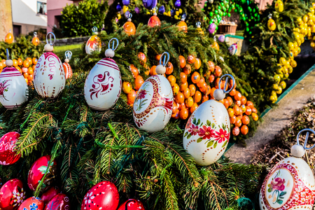 LAUF, GERMANY - APRIL 09 2015: Easter Tradition: Masterfully Colored Easter Eggs on a decorated Easter Well, famous for its pictures of Pope Francis and Benedict in Germany. Old pagan ritual of well and water blessingのeditorial素材