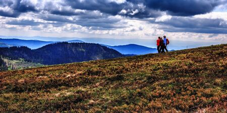 Feldberg GERMANY MAY 17 2015: People hiking at Feldberg mountain in Germany in Spring. Lovely Hills and Forests. Blue cloudy sky. Fantastic Landscapeのeditorial素材