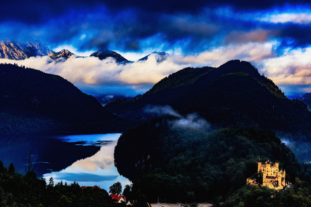 Lakes and Mountains in the Alps at Dawn. Lovely vibrant blue colors, fog and reflections in the lakeのeditorial素材