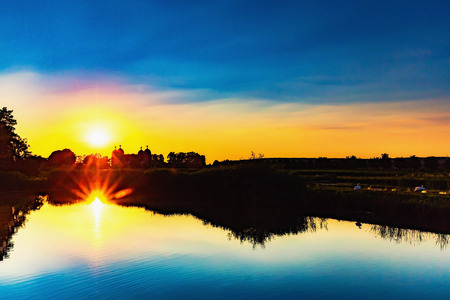 Hot Summer Sunset at Lake Seehof in Franconia, Germany. Lovely silhouettes and warm vibrant colorsの写真素材