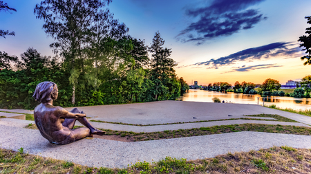 BAMBERG, GERMANY - JULY 09 2015: Bamberg City. Statue of a young woman at the ERBA river island on a warm summer eveningのeditorial素材