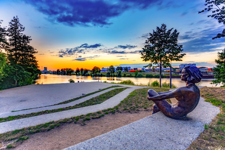 BAMBERG, GERMANY - JULY 09 2015: Bamberg City. Statue of a young woman at the ERBA river island on a warm summer eveningのeditorial素材