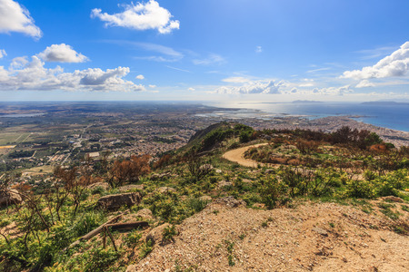 Sicilian Landscape at the Erice Mountain near Trapani, Italy. Hot autumn afternoon with some clouds. Warm colors and lovely sky. Popular travel destinationの写真素材