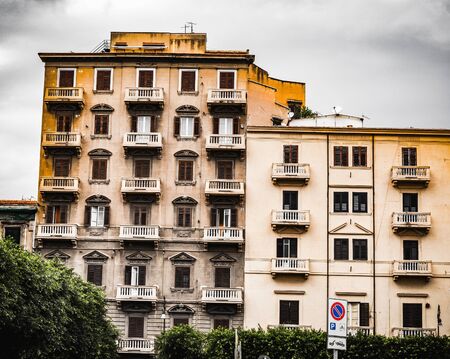 PALERMO, ITALY - OCTOBER 10 2015: Houses in the streets of Palermo on a cloudy and dramatic october dayのeditorial素材