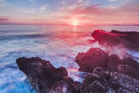 Sunrise over the Coast of Sicily. Dawn at Capo Gallo Coast near Palermo at Mondello on a warm autumn morning. Lovely sun and waves in the seaの写真素材