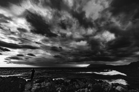 Sicily Coastline in Autumn at Sant Elia near Palermo, Italy. Dramatic clouds and waves at dawn sunrise in October at the seaの写真素材