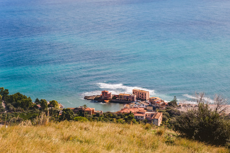 Sunrise at the Coast of Sicily. Dramatic Atmosphere with strong waves and clouds at Santa Flavia...
