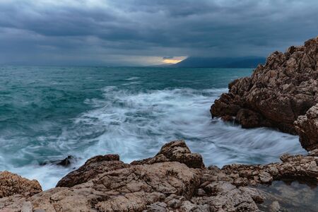 Sicily Coastline in Autumn at Sant Elia near Palermo, Italy. Dramatic clouds and waves at dawn sunrise in October at the seaの写真素材
