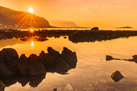 Captivating Coastal Sunset near Palermo on the island of Sicily, Italy. Lovely subtropical winter landscape at the sea. Enchanted Atmosphere in the eveningの写真素材