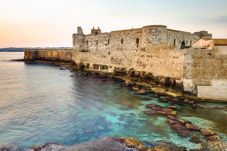 Travel Photography from Syracuse, Italy on the island of Sicily. Coastal Town sunrise with historical landmarks and monumentsの写真素材