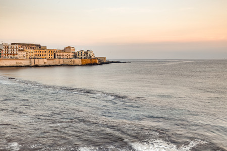 Travel Photography from Syracuse, Italy on the island of Sicily. Coastal Town sunrise with historical landmarks and monumentsの写真素材