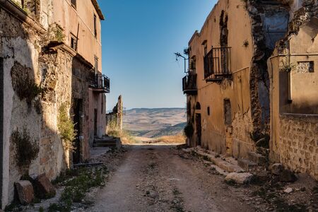 Sicilian Ghost Town of Poggioreale in Italy, Europe. Picturesque Cityscapeof an abandoned place in mediterranean landscape on a hot July summer day. Amazing tranquil and serene ghostly atmosphereの写真素材