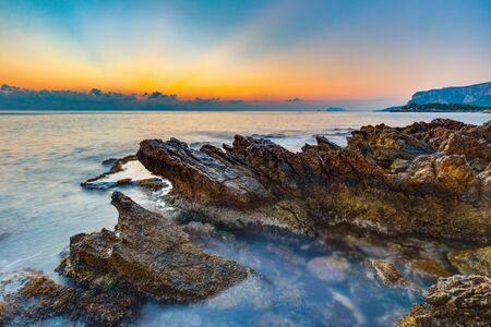 Mornig Coast Sunrise on Island Sicily in Italy, Europe with sunrays and clouds. Amazing landscape and waterの写真素材