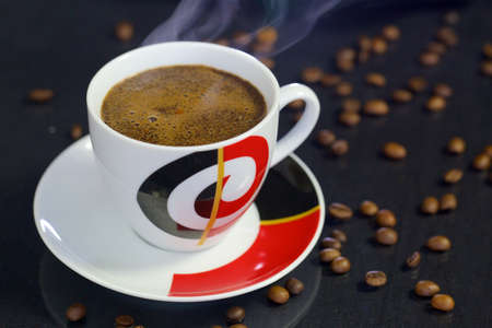 Cup of coffee on black background