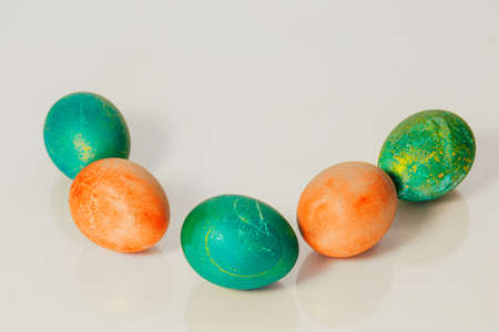 Red and green Easter eggs on white background.の写真素材