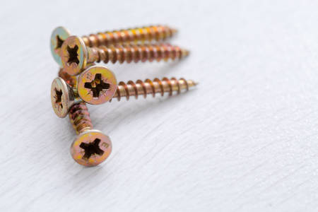 Self-tapping screws on a light background.の写真素材