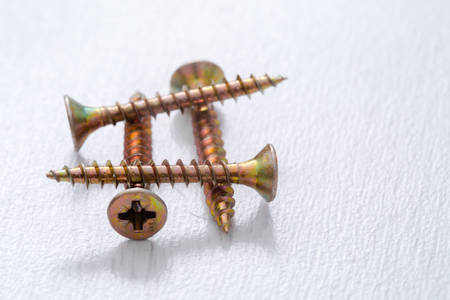 Self-tapping screws on a light background.の写真素材