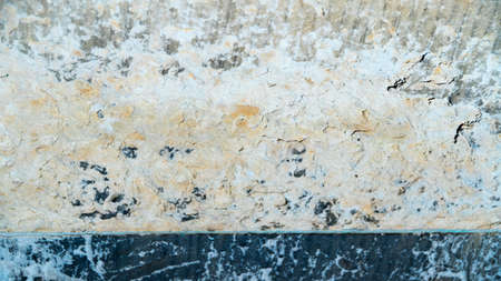 the background is grey, yellow and black stone.